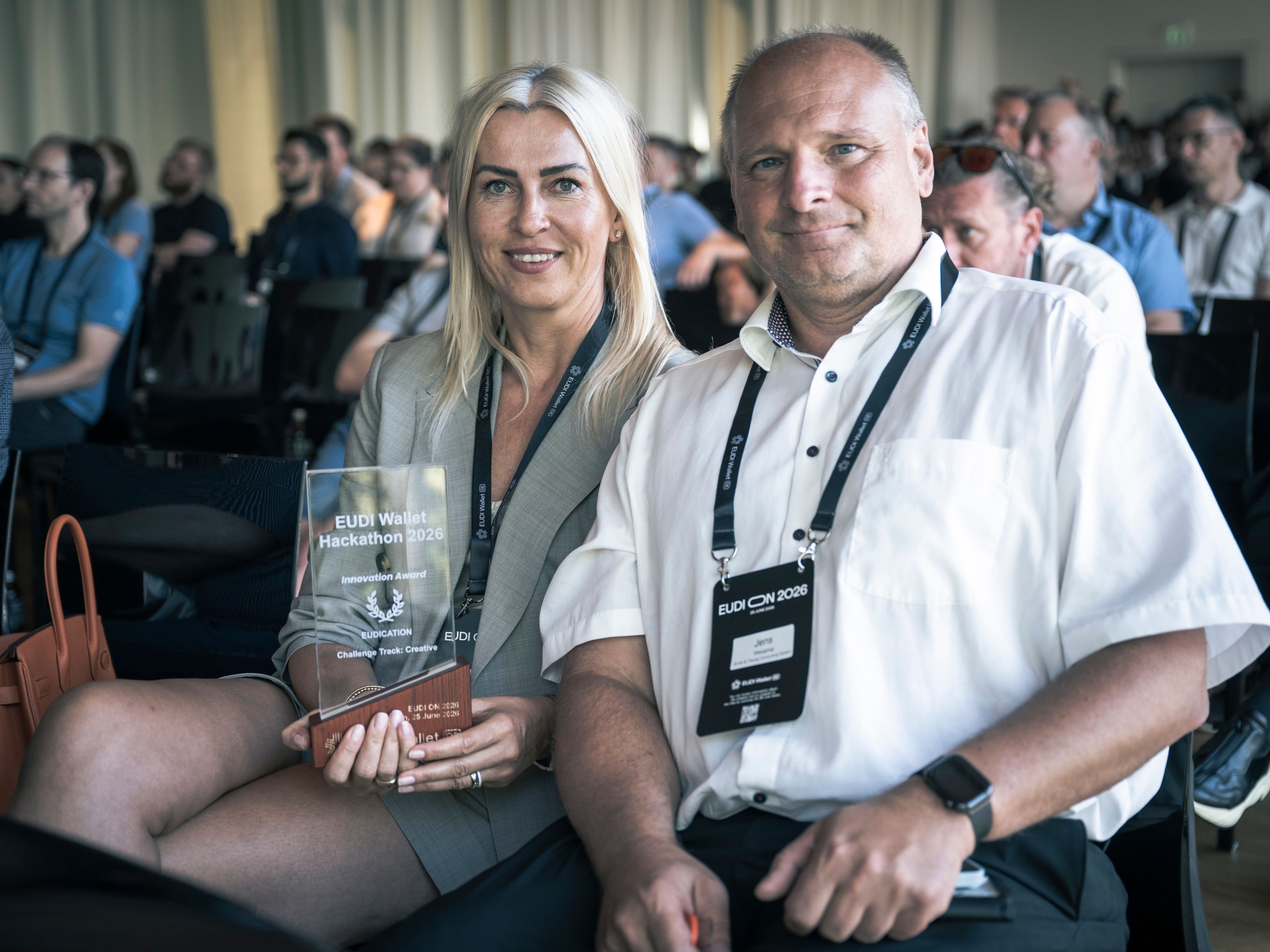  A woman and a man sit in the audience at EUDI ON 2026.